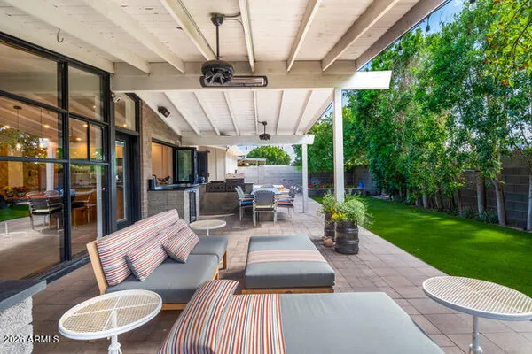 a view of a patio with couches table and chairs potted plants with sky view
