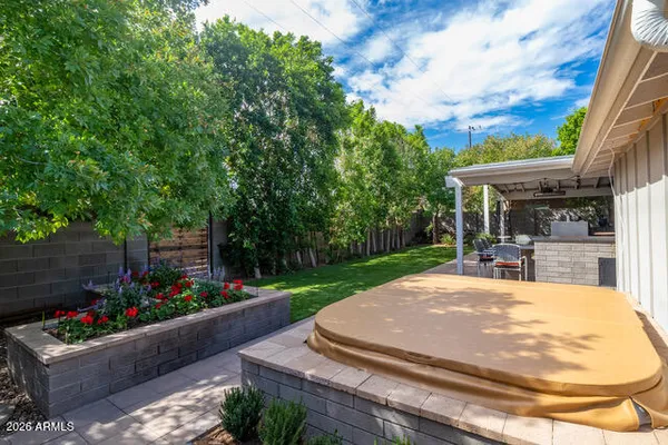 a view of a patio with table and chairs potted plants
