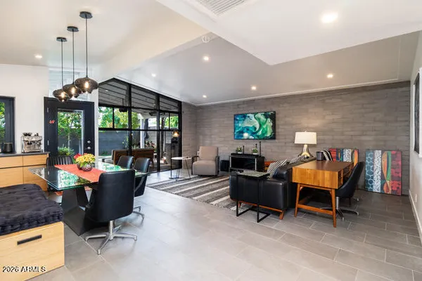 a living room with furniture a flat screen tv and a large window