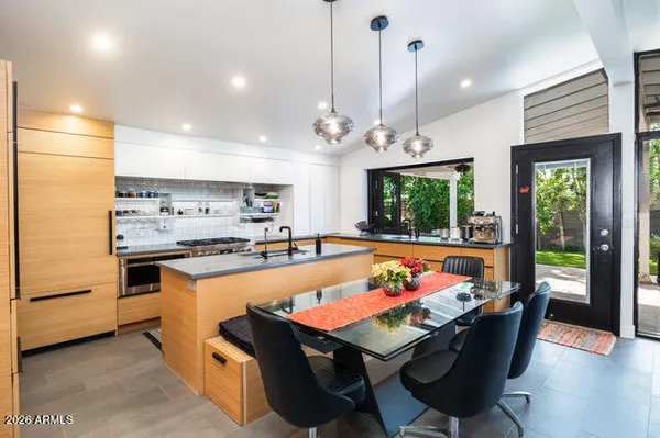 a room with stainless steel appliances kitchen island granite countertop furniture and a kitchen view