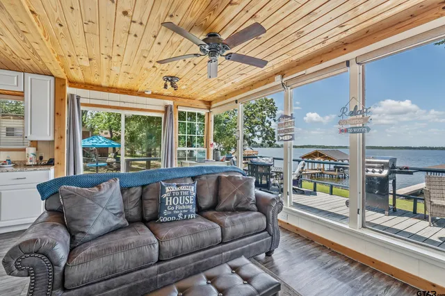 a roof deck with couch and chairs