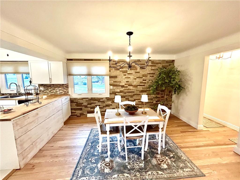 113 Memorial Street Dunbar, PA 15431 - Photo 11 of 42 a kitchen with a dining table chairs and large windows