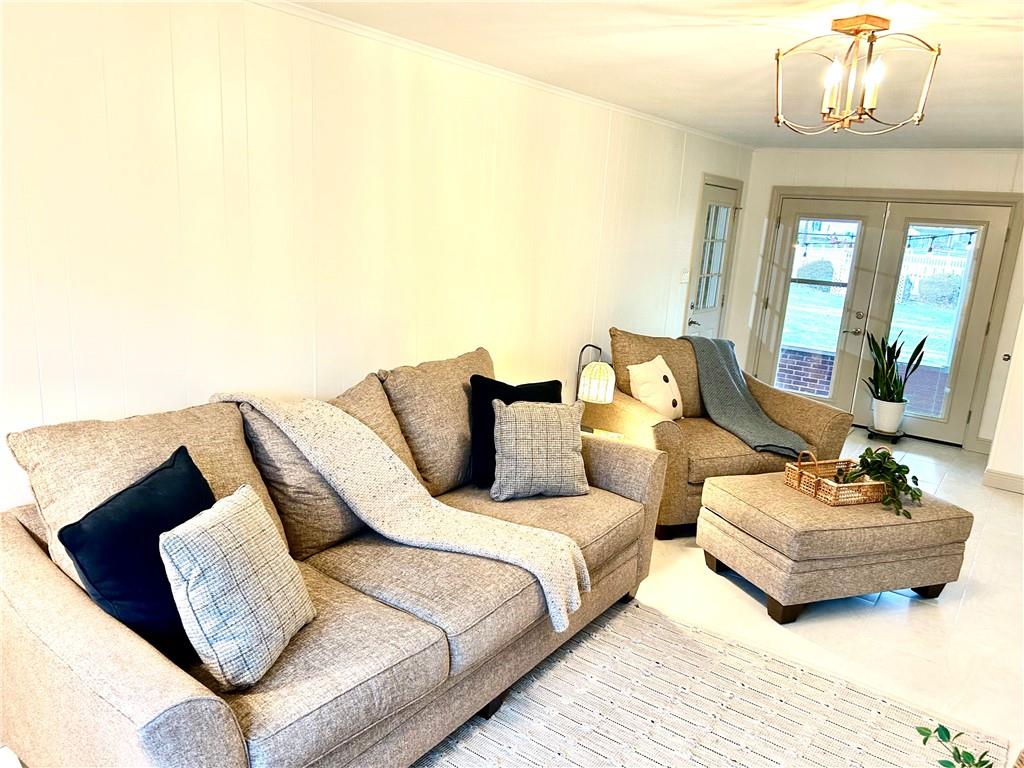 113 Memorial Street Dunbar, PA 15431 - Photo 15 of 42 a spacious bedroom with a bed a couch and a chandelier