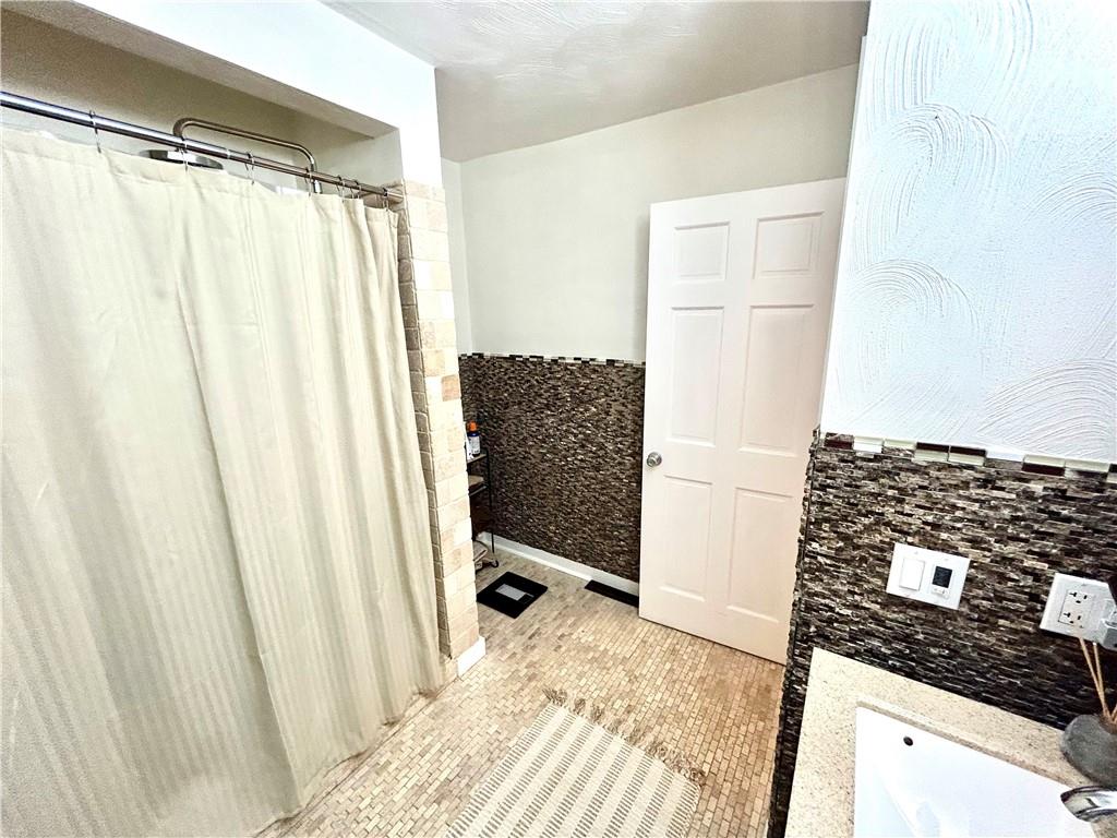 113 Memorial Street Dunbar, PA 15431 - Photo 28 of 42 a bathroom with a bathtub and shower