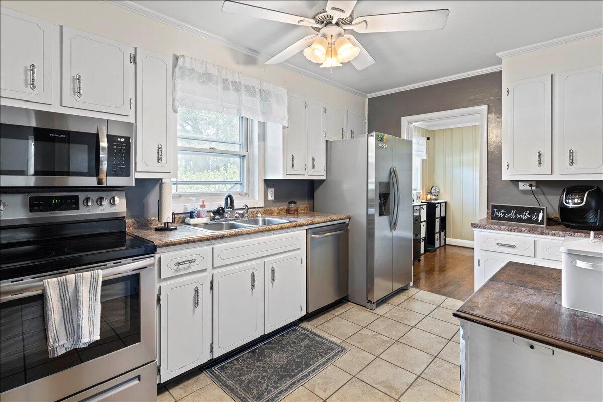 113 Ridge Street Madison Heights, VA 24572 - Photo 8 of 36 a kitchen with a sink stove and refrigerator