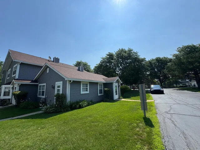 a view of a house with a backyard and a tree