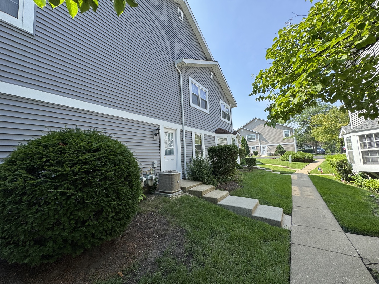458 North Lake Shore Drive Palatine, IL 60067 - Photo 22 of 25 a view of a white house next to a yard with big trees