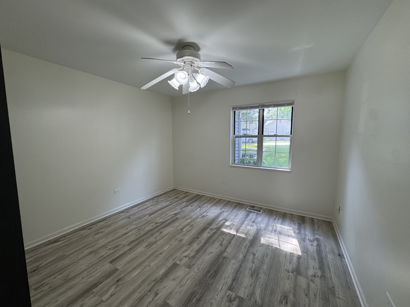 458 North Lake Shore Drive Palatine, IL 60067 - Photo 5 of 25 an empty room with wooden floor chandelier fan and windows