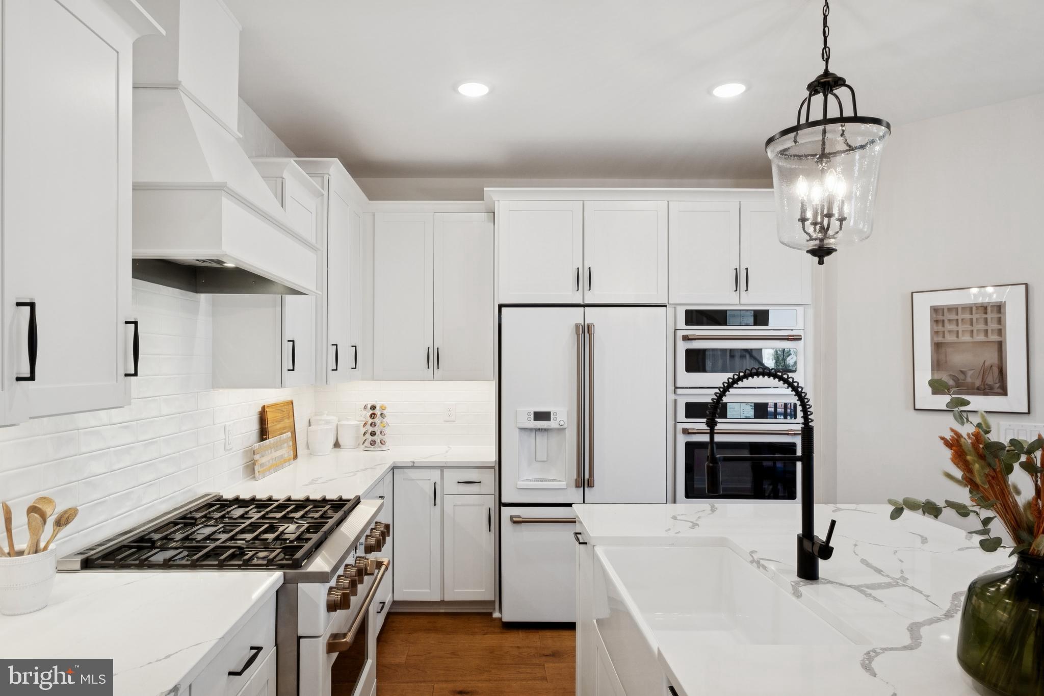 14960 Deco Circle Chantilly, VA 20151 - Photo 16 of 35 a kitchen with stainless steel appliances a stove a sink a refrigerator and cabinets