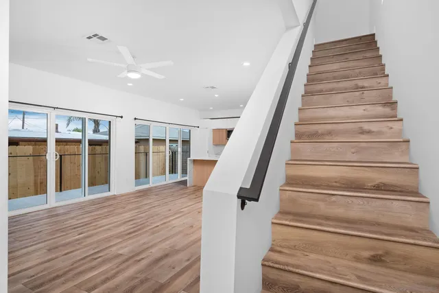 a view of staircase with wooden floor and windows