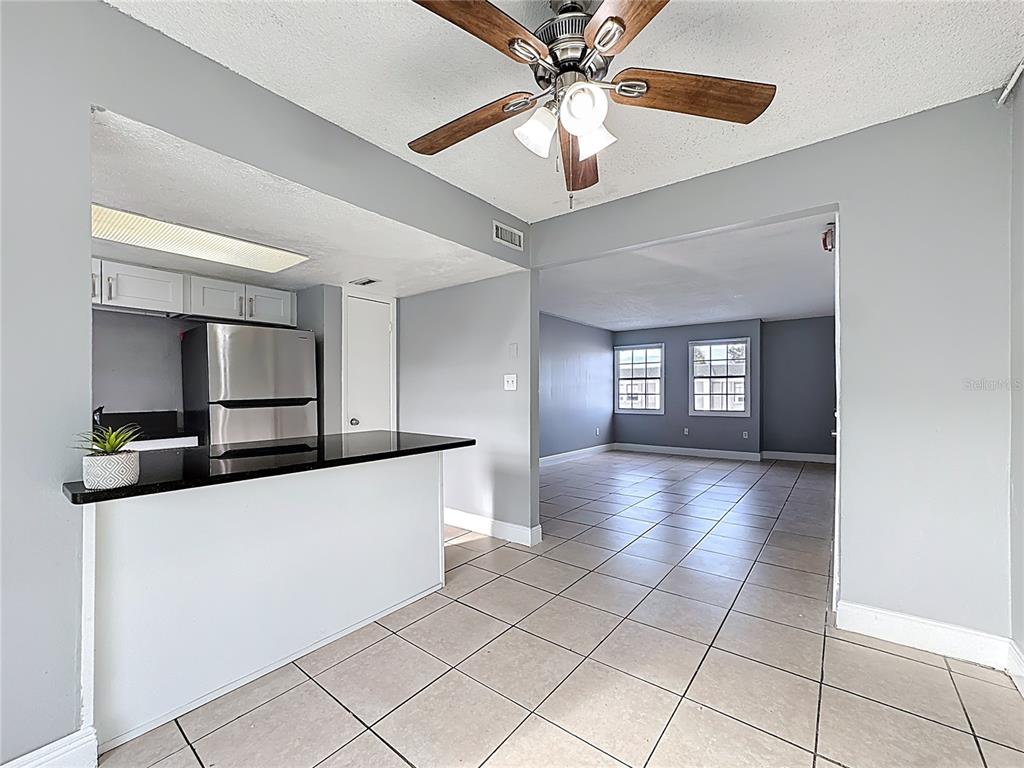 2753 L B McLeod Road, Unit D Orlando, FL 32805 - Photo 13 of 48 a view of a kitchen with a sink and a chandelier fan