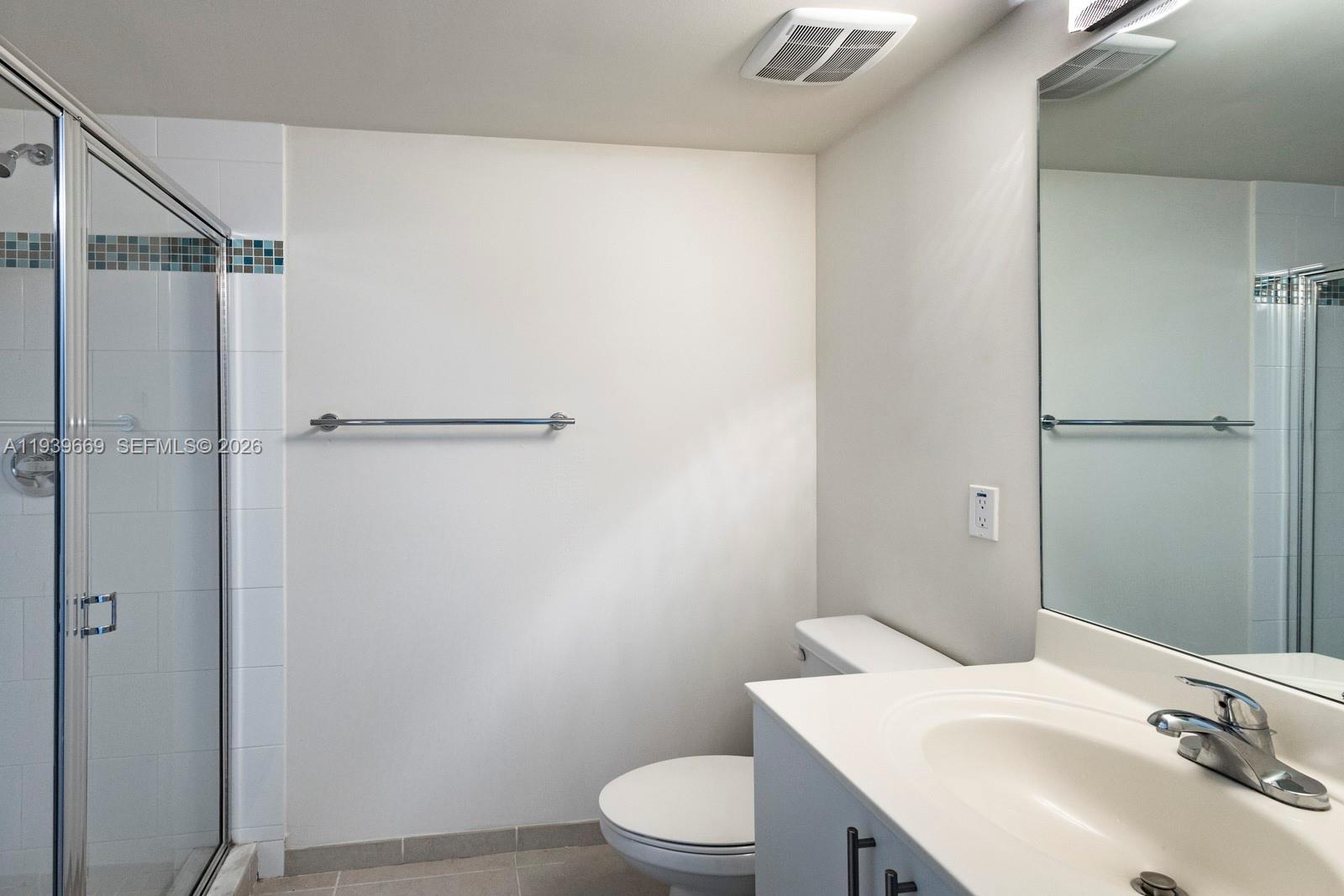 2350 Southwest 27th Avenue, Unit 809 Miami, FL 33145 - Photo 14 of 21 a bathroom with a sink toilet and a mirror