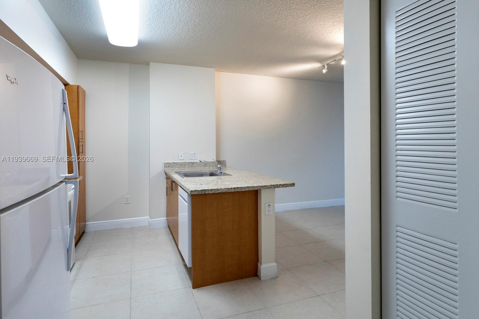 2350 Southwest 27th Avenue, Unit 809 Miami, FL 33145 - Photo 7 of 21 a bathroom with a sink and mirror