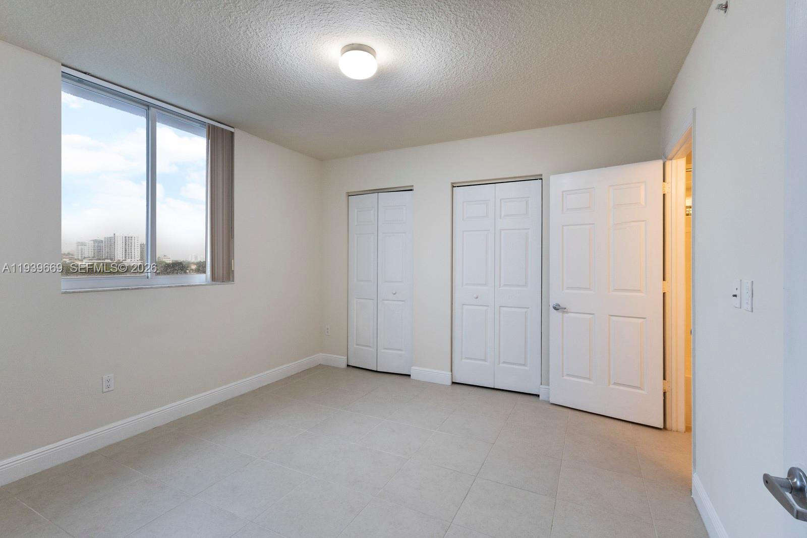 2350 Southwest 27th Avenue, Unit 809 Miami, FL 33145 - Photo 8 of 21 an empty room with windows and closet