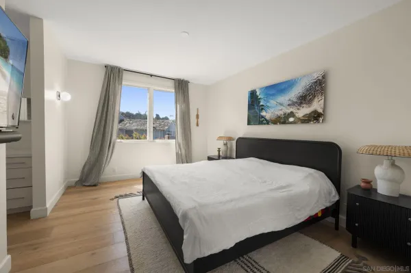 a bedroom with a large bed and a window