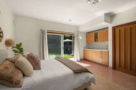 a bedroom with a bed dresser and a window