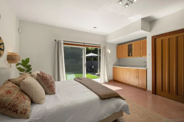 a bedroom with a bed dresser and a window