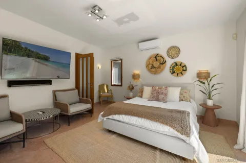 a bedroom with a bed and a couch