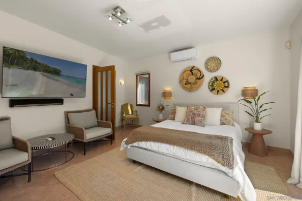 a bedroom with a bed and a couch