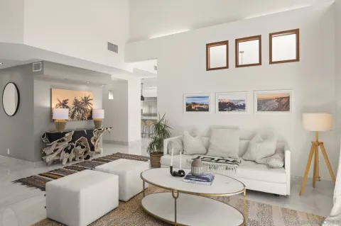 a living room with furniture a mirror and lamp
