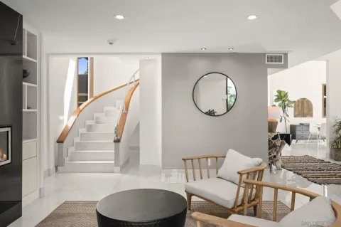 a living room with furniture a mirror and a window