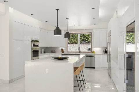 a kitchen with a stove a refrigerator and a sink
