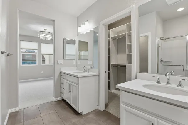 a bathroom with a double vanity sink and a mirror