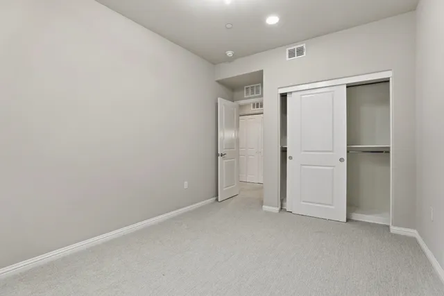 an empty room with closet area