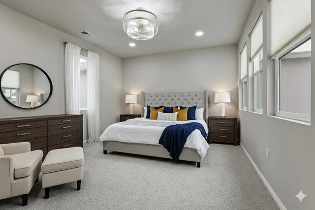 a bedroom with a bed and a chandelier