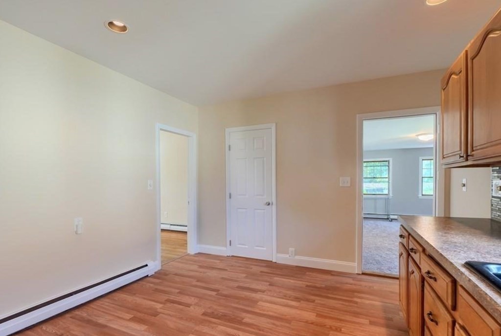 142 East Meadow Road Lowell, MA 01854 - Photo 11 of 28 a view of kitchen and wooden floor