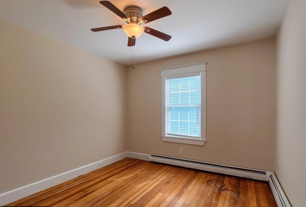142 East Meadow Road Lowell, MA 01854 - Photo 14 of 28 an empty room with window and ceiling fan