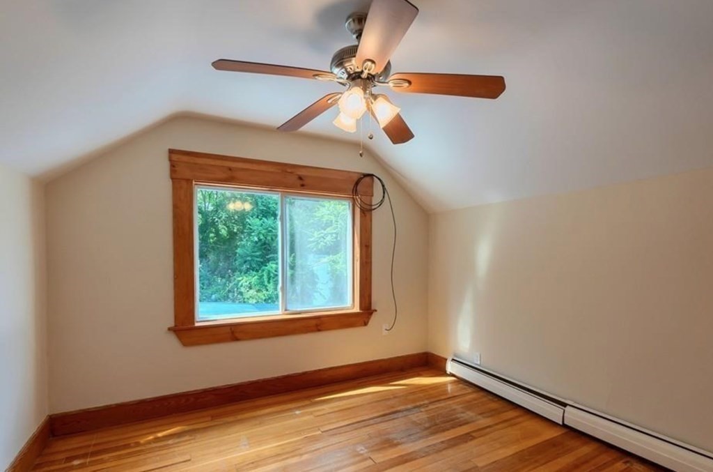 142 East Meadow Road Lowell, MA 01854 - Photo 18 of 28 a view of an empty room with window and wooden floor