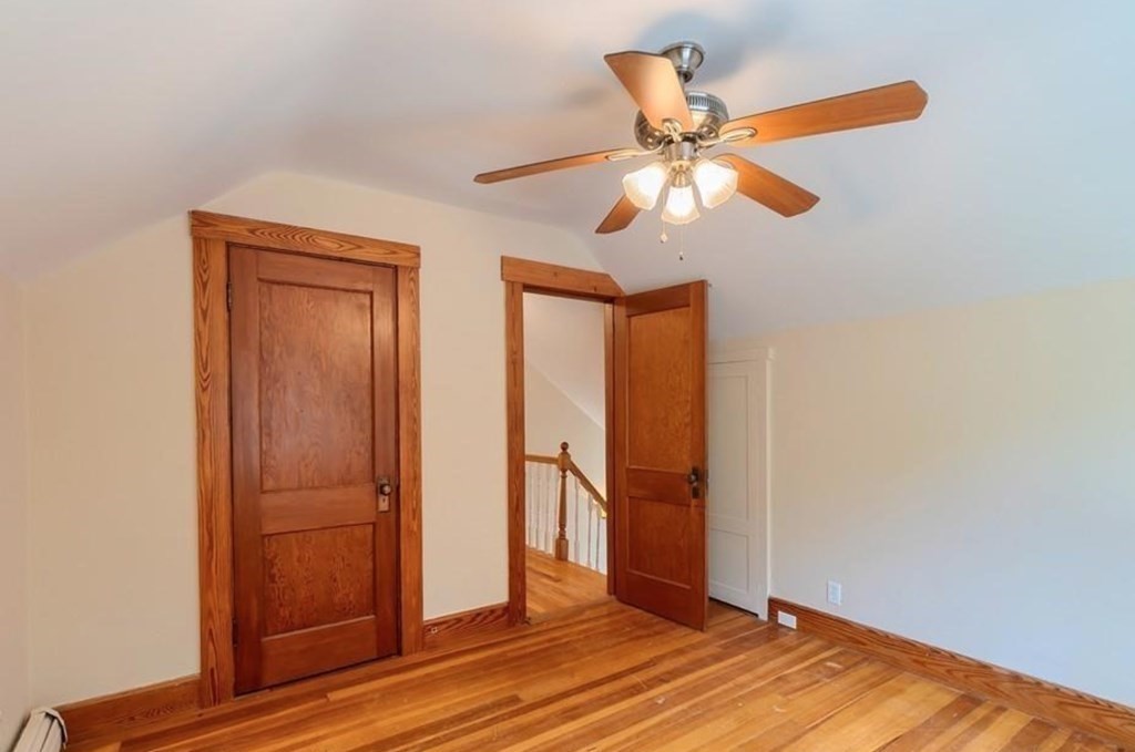 142 East Meadow Road Lowell, MA 01854 - Photo 19 of 28 a view of empty room with wooden floor and fan