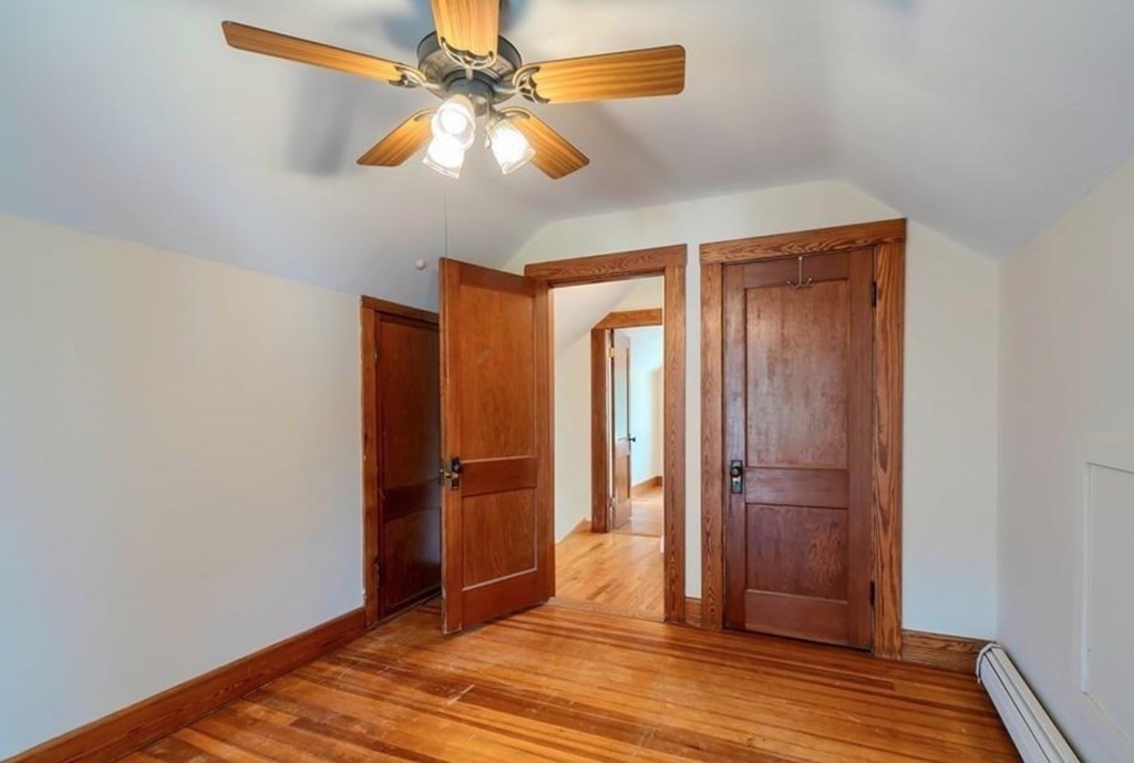 142 East Meadow Road Lowell, MA 01854 - Photo 23 of 28 an empty room with wooden floor and fan
