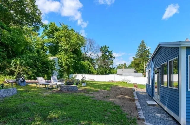 a view of backyard with swimming pool and patio