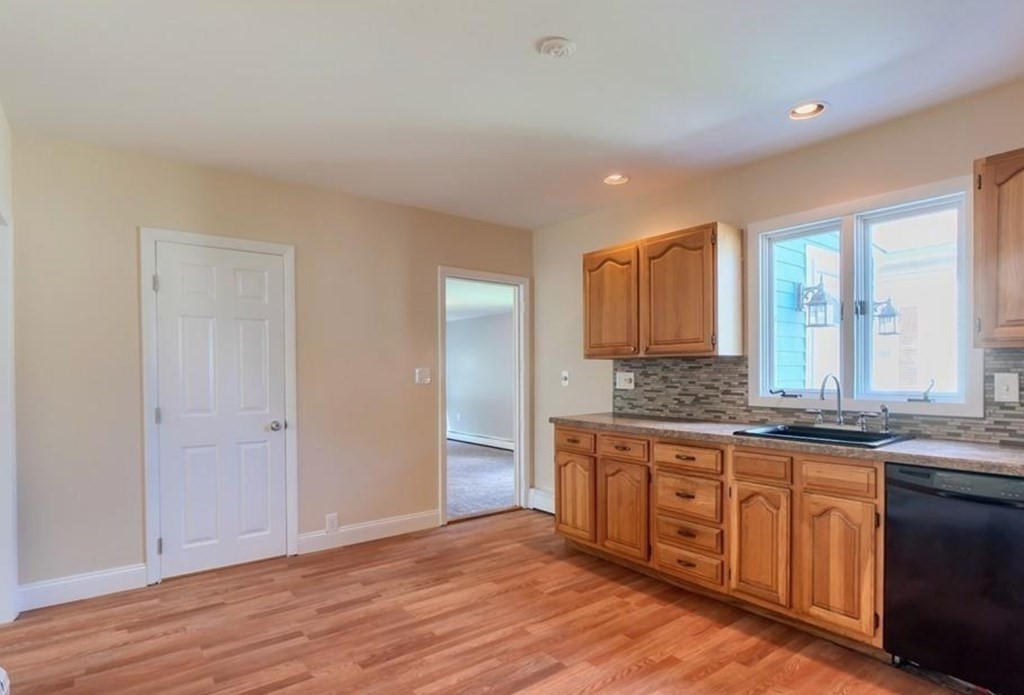 142 East Meadow Road Lowell, MA 01854 - Photo 10 of 28 a bathroom with a granite countertop sink and a mirror