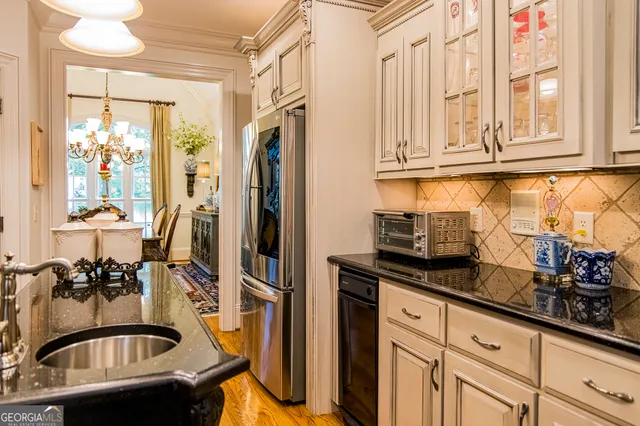 a kitchen with stainless steel appliances granite countertop a sink stove and cabinets