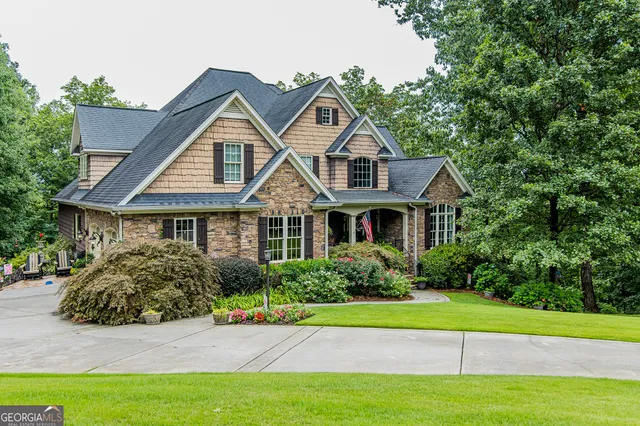 a front view of a house with a yard and trees