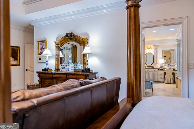 a room with furniture and paintings on the wall