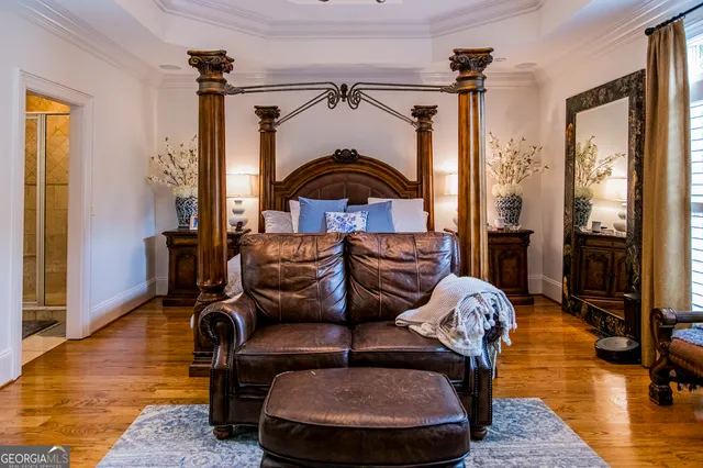 a living room with furniture a flat screen tv and a window