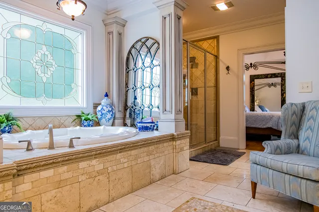 a bed sitting in a bedroom next to a window