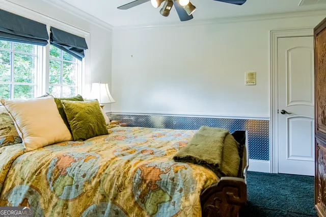 a view of a hallway with wooden floor and a rug