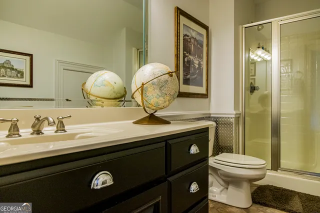 a bathroom with a toilet and a shower