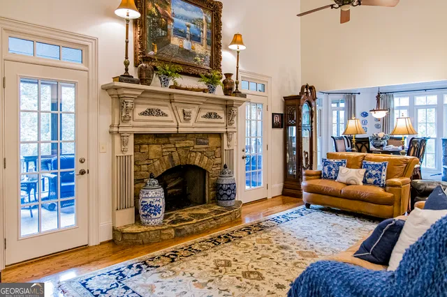 a living room with furniture ceiling fan and a rug