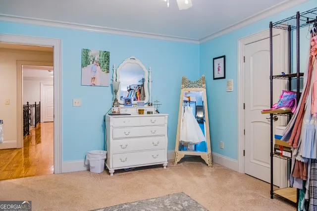 a view of a chair and table in backyard with potted plants