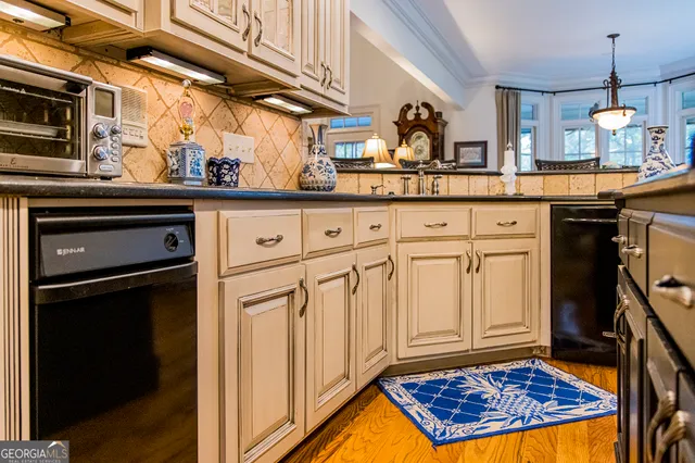 a kitchen with stainless steel appliances granite countertop a sink stove and cabinets