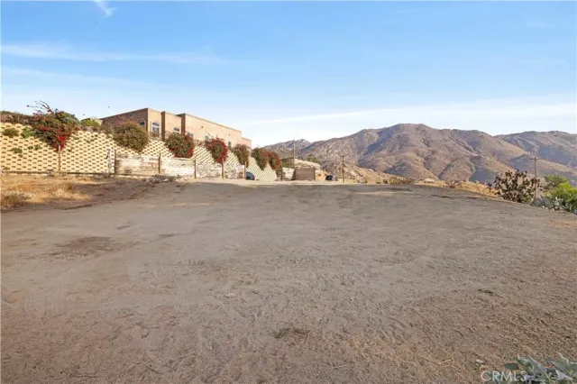 a view of a dry yard with mountain view