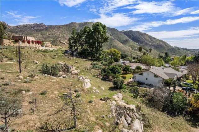 a view of a dry yard covered with snow in front of house
