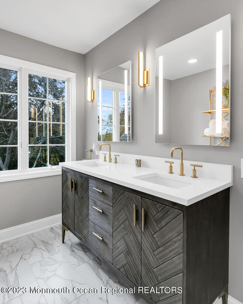 124 Rumson Road Rumson, NJ 07760 - Photo 24 of 52 a bathroom with a sink double vanity and a mirror