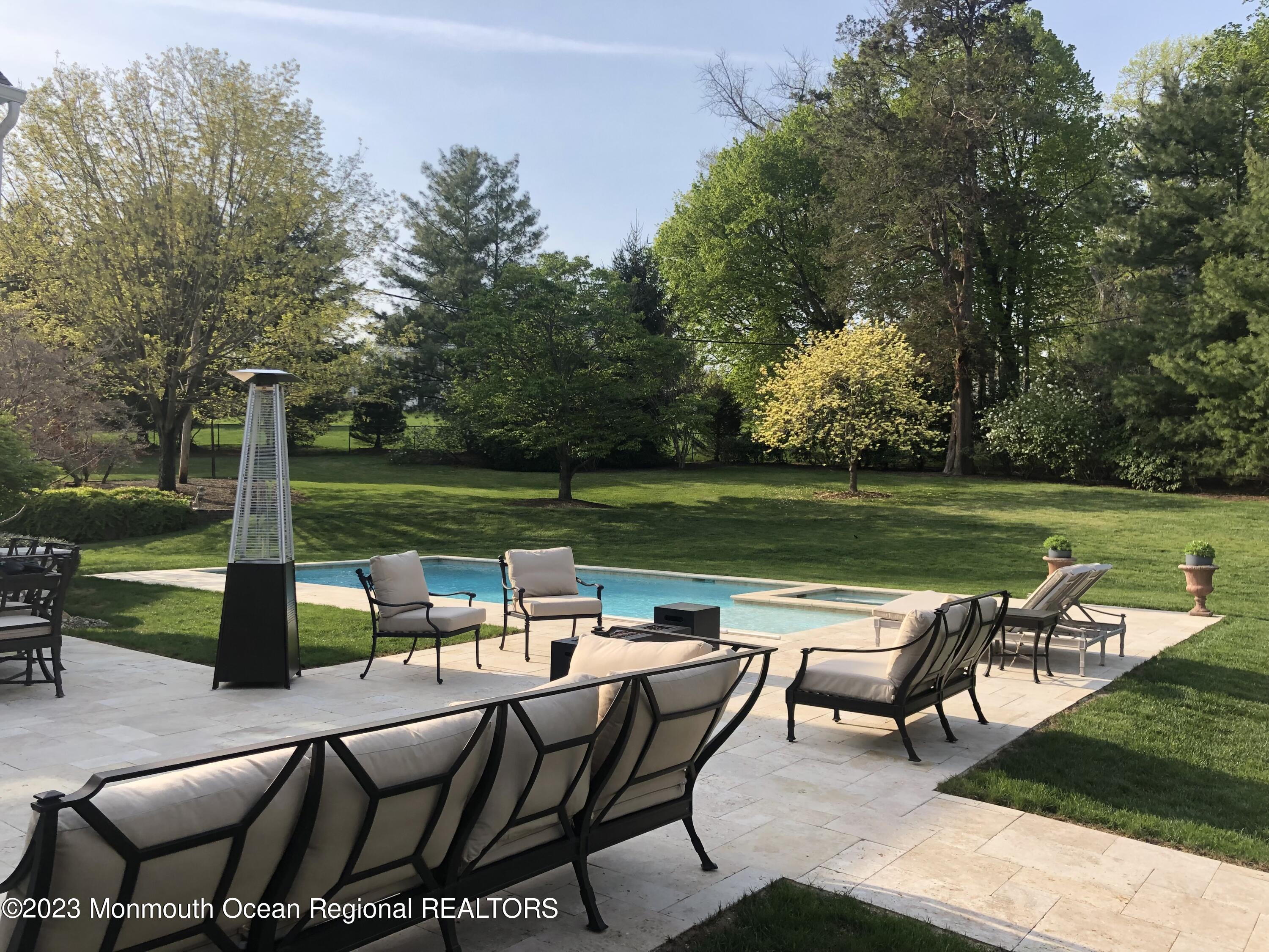 124 Rumson Road Rumson, NJ 07760 - Photo 36 of 52 an outdoor sitting area with furniture and garden